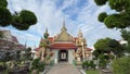 Giant statues guard in front of the entrances to inside Wat Arun temple