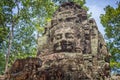 Giant stone face on an ancient temple in Angkor Wat, Siem Rep Cambodia