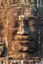 Giant stone face at Bayon Temple in Cambodia Royalty Free Stock Photo