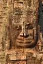 Giant stone face at Bayon Temple in Cambodia Royalty Free Stock Photo