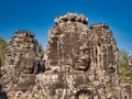 Giant stone faces in temple ruins at the ancient Khmer site of Angkor Thom near Siem Reap in Cambodia Royalty Free Stock Photo