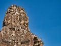 Giant stone faces in temple ruins at the ancient Khmer site of Angkor Thom near Siem Reap in Cambodia Royalty Free Stock Photo