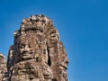 Giant stone faces in temple ruins at the ancient Khmer site of Angkor Thom near Siem Reap in Cambodia Royalty Free Stock Photo