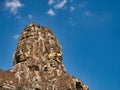 Giant stone faces in temple ruins at the ancient Khmer site of Angkor Thom near Siem Reap in Cambodia Royalty Free Stock Photo