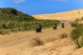 Bikers travelling through the giant sand dunes near Cape Reinga, New Zealand