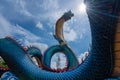 Giant Thai Naga Statue with blue sky clouds in the Phu Manorom Temple, Royalty Free Stock Photo