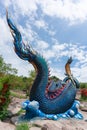 Giant Thai Naga Statue with blue sky clouds in the Phu Manorom Temple, Royalty Free Stock Photo