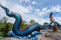 Giant Thai Naga Statue with blue sky clouds in the Phu Manorom Temple, Royalty Free Stock Photo