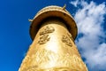 Giant Tibetan Buddhist prayer wheel of Guishan Dafo temple bottom view over blue sky in Dukezong old town Shangri-La Yunnan China Royalty Free Stock Photo