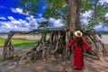 The giant tree, grow for many years that big roots show out from soil. It looks very big when comparing with model woman. Taken at