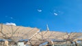 Giant umbrellas at Al-Nabawi Mosque of Medina and blue sky