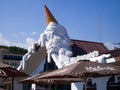 A giant vanilla ice cream cone trickles down McDonald`s brown roof