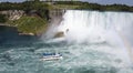 Giant Waterfalls with Mist coming of Cruise Ship `Maid of the Mist` tourist Niagara Falls on the US Canadian Border