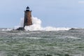 Giant Wave Surrounds Stone Lighthouse in Maine