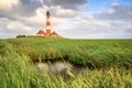 Giant Westerheversand lighthouse under the cloudy sky in Germany