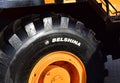 Giant wheels and tires on huge mining truck BELAZ with logo BELSHINA JSC production of one of the largest automobile tire