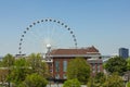 Giant white ferris wheel behind a vintage red brick building in urban Atlanta Georgia