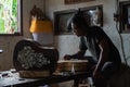 GIANYAR,BALI/INDONESIA-MAY 30 2019: A guitar craftsman creating a sketch on the guitar body at the guitar workshop owned by I