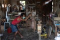 GIANYAR,BALI/INDONESIA-MAY 30 2019: A guitar craftsman is measuring and make sure it is precision in a wooden guitar workshop
