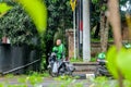 Gianyar City Park, Bali, Indonesia February 12, 2021: Online motorcycle taxi activities in Bali, waiting for orders on the side
