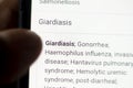 Giardiasis News on the phone.Mobile phone in hands. selective focus and chromatic aberration effects