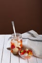 Marinated various vegetables in a glass jar on white wooden background Royalty Free Stock Photo