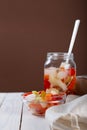 Marinated various vegetables in a glass jar on white wooden background Royalty Free Stock Photo