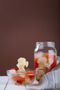 Marinated various vegetables in a glass jar on white wooden background Royalty Free Stock Photo