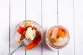 Marinated various vegetables in a glass jar on white wooden background Royalty Free Stock Photo