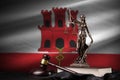 Giblartar flag with statue of lady justice, constitution and judge hammer on black drapery. Concept of judgement and
