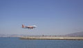 Airplane coming into land on a small runway surrounded by water in Gibraltar Royalty Free Stock Photo