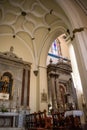 Gibraltar - 3 August 2022 - Altars with saints and wooden pews in lowlight and decorated ceiling inside St Mary Crowned church Royalty Free Stock Photo