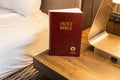 Gideons Bible in hotel room on bedside table Royalty Free Stock Photo