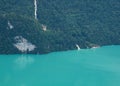 Giessbach Falls and historic hotel. Ship waiting at the shore of turquoise Lake Brienz