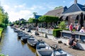 GIETHOORN, NETHERLANDS - JULY 17,2016: Tourists renting boats on the canal between houses in the famous village of Giethoorn, The