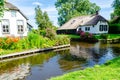 Giethoorn, Netherlands: Landscape view of famous Giethoorn village with canals and rustic thatched roof houses. The beautiful