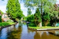 Giethoorn, Netherlands: Landscape view of famous Giethoorn village with canals and rustic thatched roof houses. The beautiful