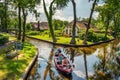 Tourists on a sightseeing boat in the village of Giethoorn, Netherlands Royalty Free Stock Photo