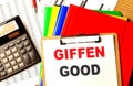GIFFEN GOOD text on clipboard with calculator and color folder Royalty Free Stock Photo