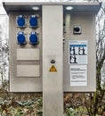 Connection sockets and distribution station for the power supply of motor homes and caravans at one parking place