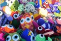 Homemade crocheted colorful fanciful figures on the stand of a flea market