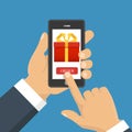 Gift app page on smartphone screen. Hand hold smartphone.
