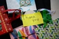 Gift bags with colorful stringers and a thank you note. Royalty Free Stock Photo