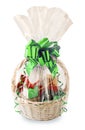 Gift basket, hamper packed in transparent paper with a big green bow isolated on a white background Royalty Free Stock Photo