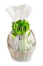 Gift basket packed in transparent paper with big green bow isolated on a white background Royalty Free Stock Photo