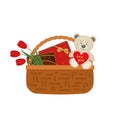 Gift basket for Valentine`s Day. Wicker basket with boxes of chocolates and red flowers Royalty Free Stock Photo