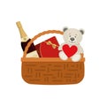 Gift basket for Valentine`s Day. Wicker basket with a red box of chocolates and a bottle of wine Royalty Free Stock Photo