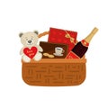 Gift basket for Valentine`s Day. Wicker basket with a red box of chocolates, cookies and a bottle of wine Royalty Free Stock Photo