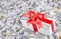 Gift with big red bow ribbon made of united states dollars curr Royalty Free Stock Photo