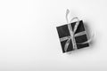 Gift black box with silver ribbon on white background. Top view, copy space Royalty Free Stock Photo